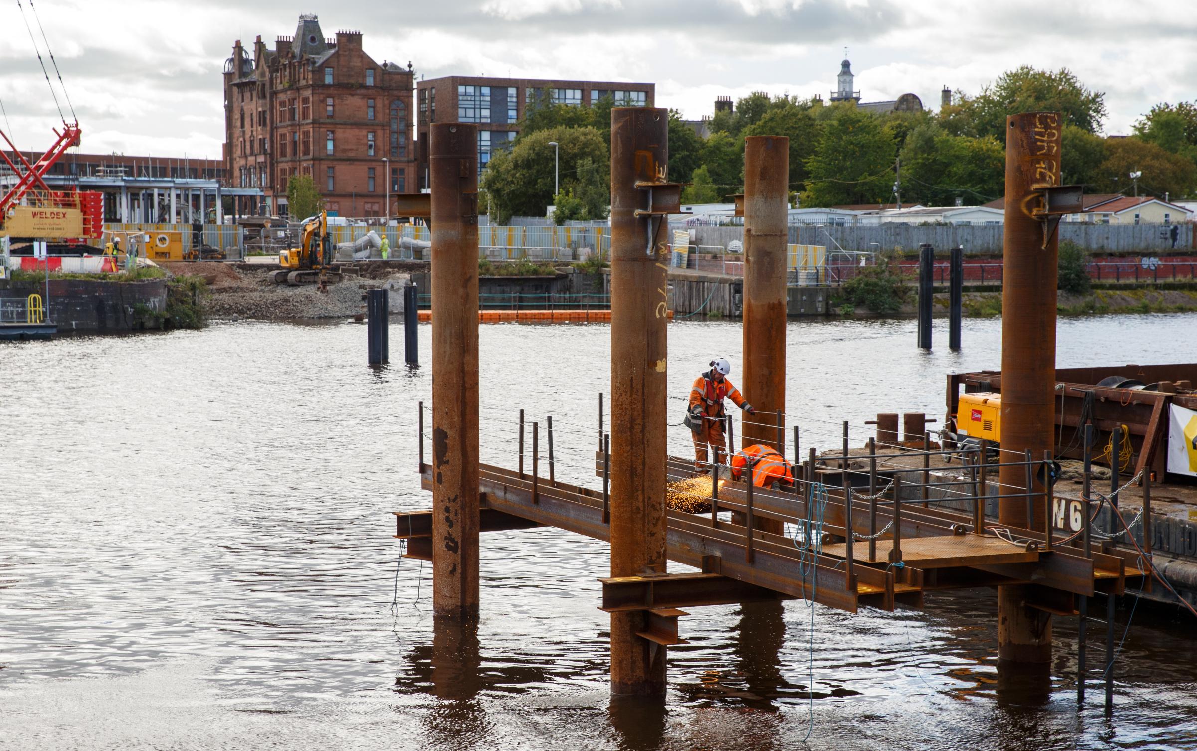 Construction of the Govan-Partick pedestrian bridge in Glasgow. The single-span swing bridge will connect Water Row in Govan and Pointhouse Quay at the Riverside museum. Photograph by Colin Mearns.