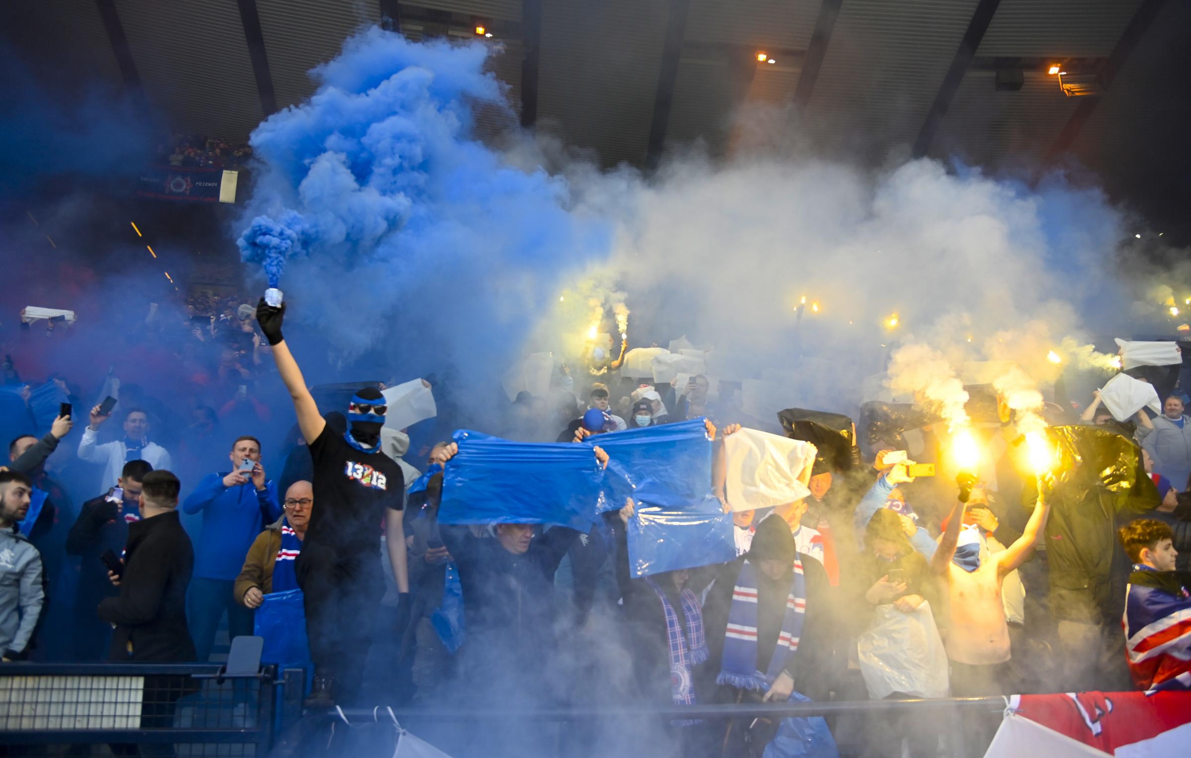 Sections of both sets of supporters put on pyrotechnic displays inside Hampden